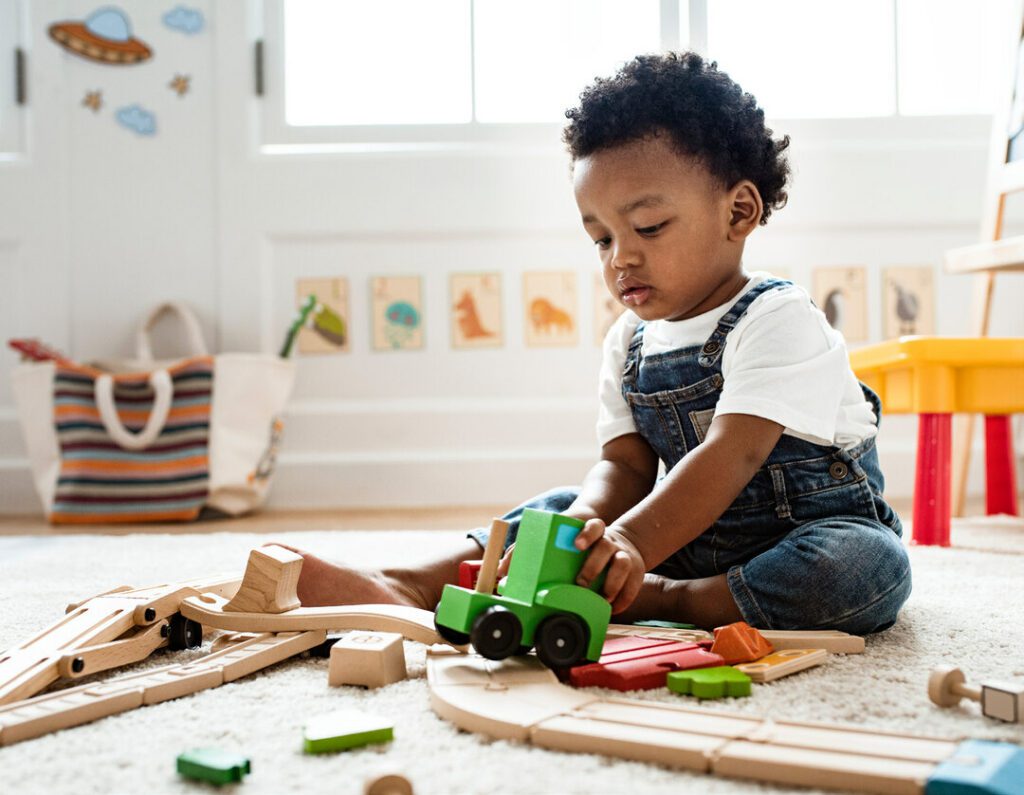 child and wooden train set