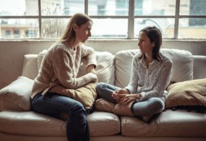 Female teen and female adult talking.