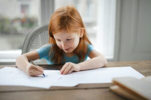 A girl drawing in a sketchbook
