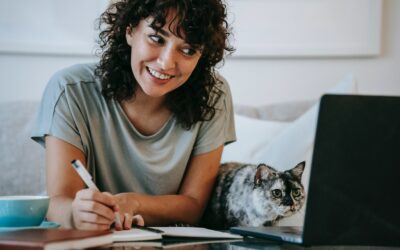 woman with cat using computer
